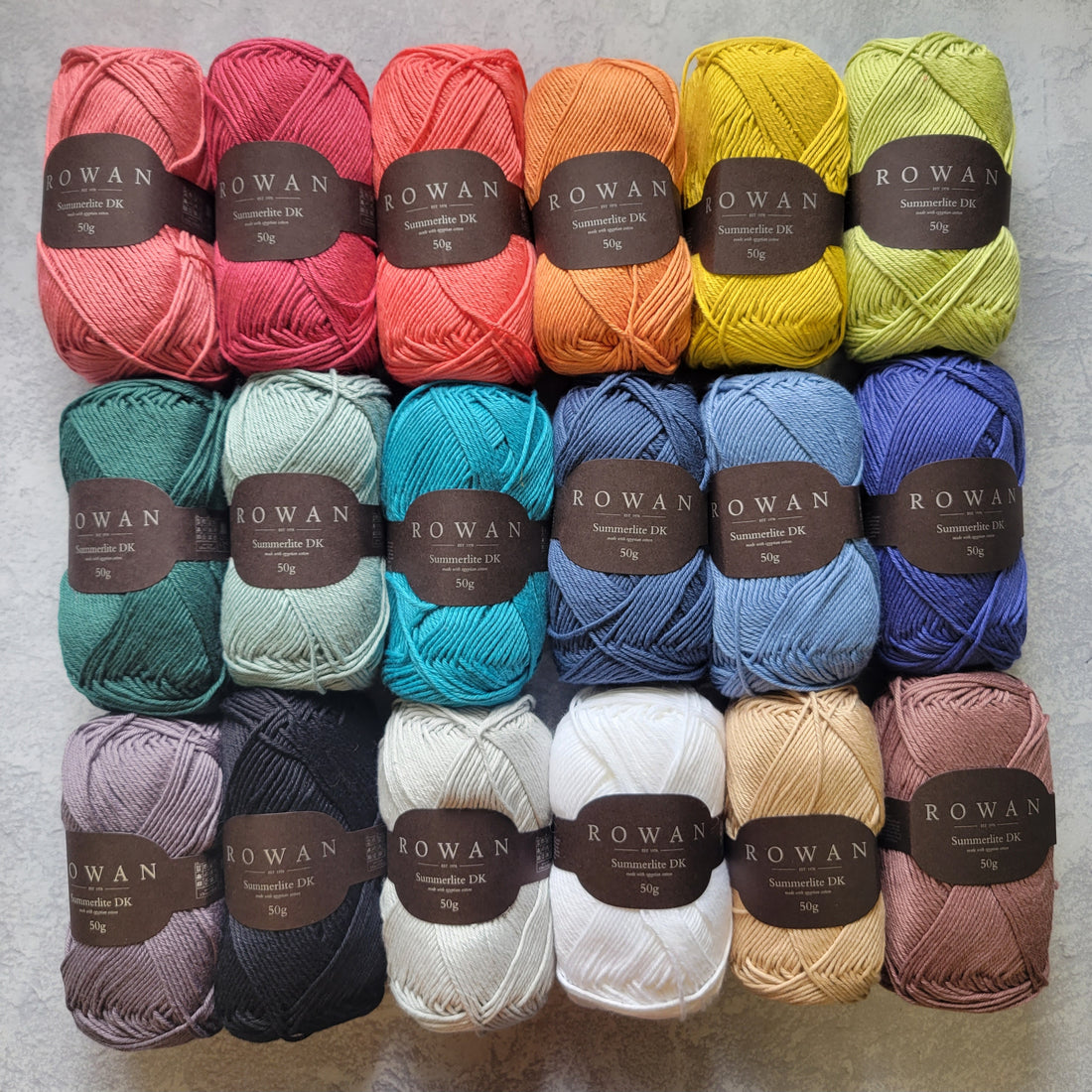  a rainbow of cotton balls of yarns
